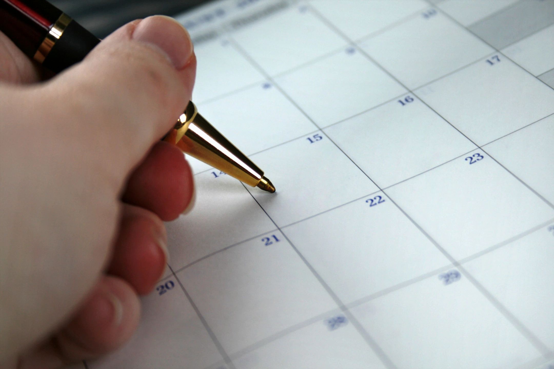 Pen resting on a calendar for planning
